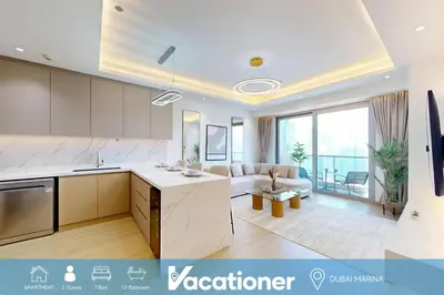 a large kitchen and living room with a couch at Stunning One Bedroom in the Marina in Dubai