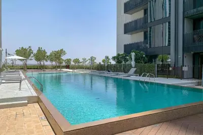 a large swimming pool in front of a building at Creek Gate - Spacious Two Bed in Creek Harbour in Dubai