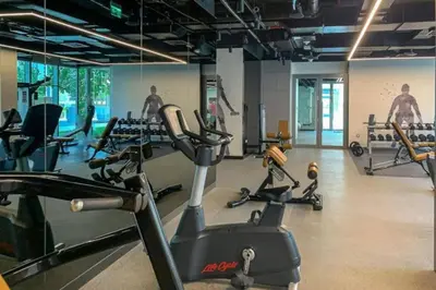 a gym with several cardio machines in a room at Creek Gate - Spacious Two Bed in Creek Harbour in Dubai