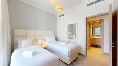 two beds in a white room with a bedroom at Creek Gate - Spacious Two Bed in Creek Harbour in Dubai