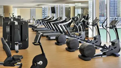 a gym with rows of treadmills and exercise bikes at Vacationer I Elegant 2 Bed I City View I Close to Barasti Beach I Marina Heights in Dubai
