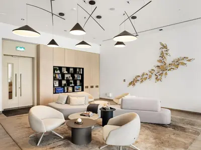 a living room with a white couch and chairs at NEW Luxury 2 Bed in Belgravia Heights in JVC in Dubai