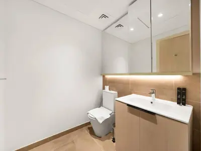 a bathroom with a toilet and a sink at NEW Luxury 2 Bed in Belgravia Heights in JVC in Dubai