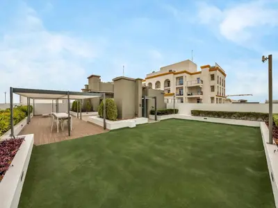 an image of a backyard with a green lawn at NEW Luxury 2 Bed in Belgravia Heights in JVC in Dubai