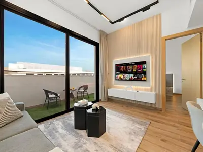 a living room with a couch and a tv at Brand New Luxury Apartment in JVC with Padel Court in Dubai