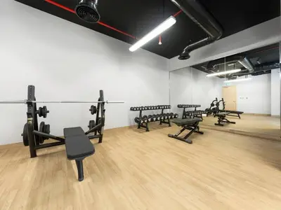 a gym with rows of exercise equipment in a room at Brand New Luxury Apartment in JVC with Padel Court in Dubai