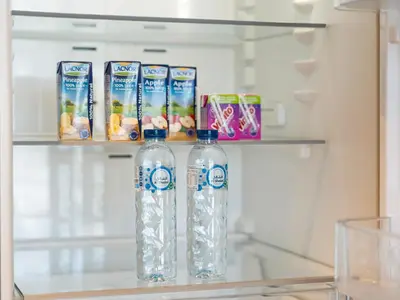 two bottles of water sitting on a shelf in a refrigerator at The Dubai Mall Suite Luxury 1-Bed Near Burj Khalifa in Dubai