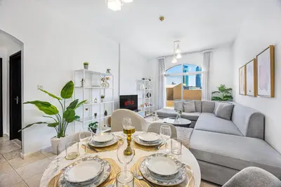 a living room with a couch and a table at Luxury 2BR Haven with Expansive Terrace and Elegance in Dubai