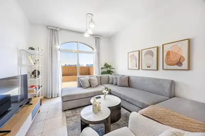 a living room with a couch and a tv at Luxury 2BR Haven with Expansive Terrace and Elegance in Dubai