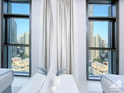 a bathroom with large windows with a view of a city at Luxury 4BR Apartment at Burj Crown I Balcony Views in Dubai