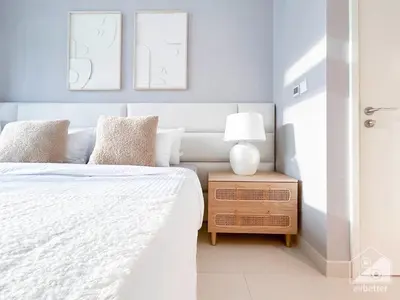a bedroom with a bed and a table with a lamp at Luxury 4BR Apartment at Burj Crown I Balcony Views in Dubai