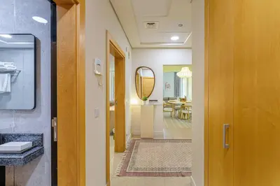 a hallway leading to a room with a mirror at Breathtaking 1BR Sea-View Palm Apt Beach & Pool in Dubai