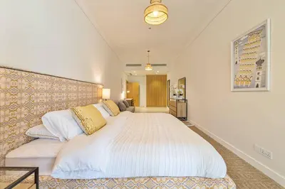 a bedroom with a large white bed in a room at Breathtaking 1BR Sea-View Palm Apt Beach & Pool in Dubai