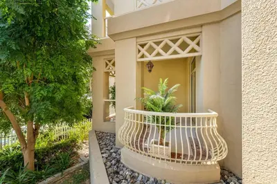 a building with a balcony with a plant in it at Breathtaking 1BR Sea-View Palm Apt Beach & Pool in Dubai