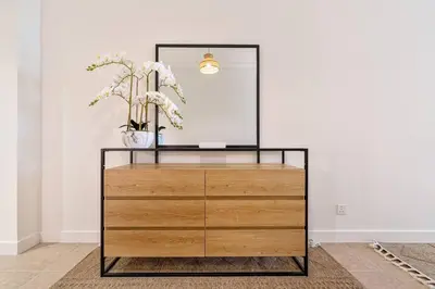 a dresser with a mirror on top of it at Breathtaking 1BR Sea-View Palm Apt Beach & Pool in Dubai