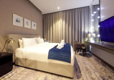a hotel room with a bed and a tv at Elegant Studio in Business bay Near Dubai Mall in Dubai