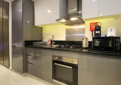 a kitchen with a stove and a microwave at Elegant Studio in Business bay Near Dubai Mall in Dubai