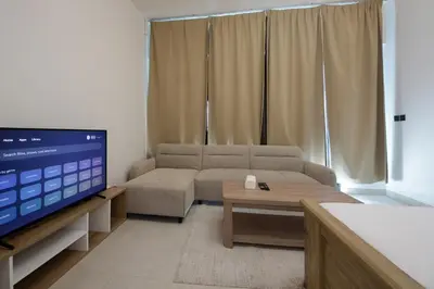 a living room with a couch and a flat screen tv at Modern Studio Stay in Business Bay Near Dubai Mall in Dubai