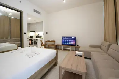 a living room with a bed and a couch at Modern Studio Stay in Business Bay Near Dubai Mall in Dubai