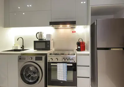 a kitchen with a stove and a washing machine at Elegant Studio in Binghatti Canal Near Dubai Mall in Dubai