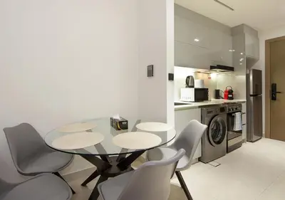 a dining room with a table and chairs in a kitchen at Elegant Studio in Binghatti Canal Near Dubai Mall in Dubai