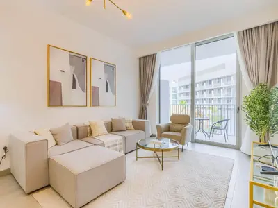 a living room with a couch and a table at TRPS - Luma 22, Jumeirah Village Circle - Chic 1BR Modern Sanctuary in Dubai