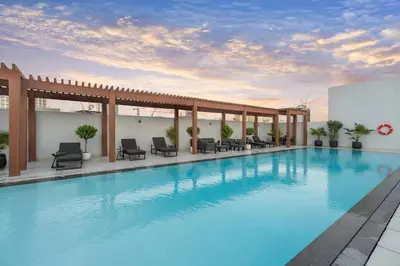 a pool on the rooftop of a hotel at TRPS - Luma 22, Jumeirah Village Circle - Chic 1BR Modern Sanctuary in Dubai