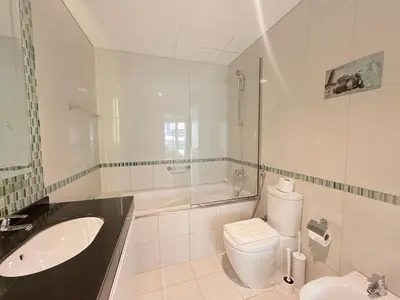 a white bathroom with a sink and a toilet at Premium Stay - Damac Heights 1BR in Dubai