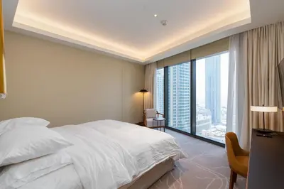a bedroom with a white bed and a large window at Address Residences, Dubai Opera 1, Downtown - Mint Stay in Dubai