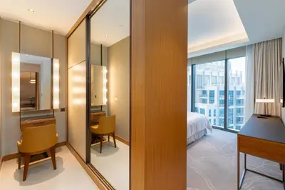 a hotel room with a view of a bedroom at Address Residences, Dubai Opera 1, Downtown - Mint Stay in Dubai