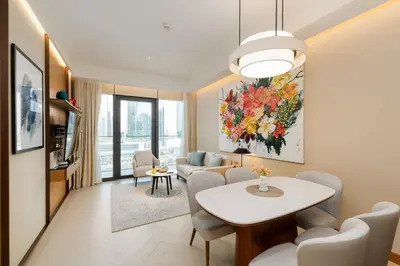 a living room with a table and chairs and a dining room at Address Residences, Dubai Opera 1, Downtown - Mint Stay in Dubai