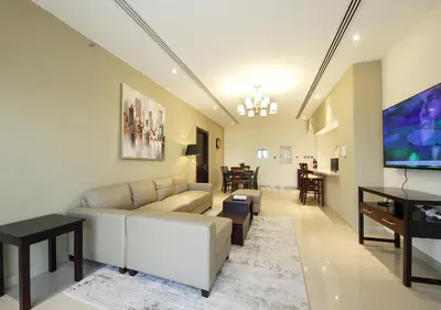 a living room with a couch and a flat screen tv at 2BR Chic Elite Suite in Downtown near Dubai Mall in Dubai