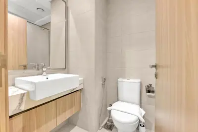 a bathroom with a white toilet and a sink at Amazing Studio in Azizi Riviera 1 in Dubai