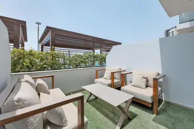 a balcony with two chairs and a table at Amazing Studio in Azizi Riviera 1 in Dubai