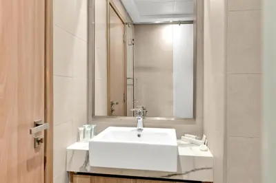 a bathroom with a white sink and a mirror at Amazing Studio in Azizi Riviera 1 in Dubai