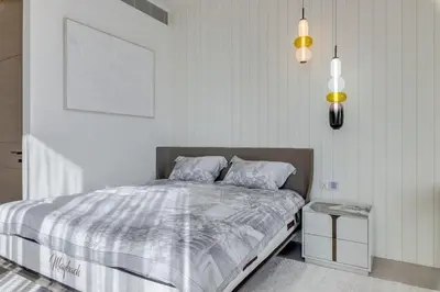 a bedroom with a bed and two pillows on it at ADDRESS Residences by Happy Season in Dubai