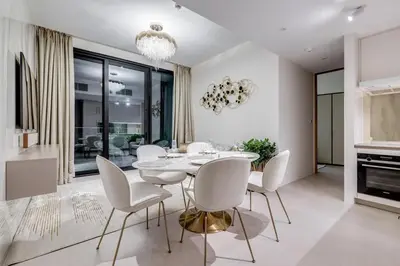 a dining room with a white table and chairs at ADDRESS Residences by Happy Season in Dubai