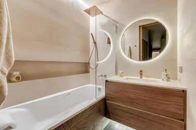 a bathroom with a tub and a sink and a mirror at ADDRESS Residences by Happy Season in Dubai