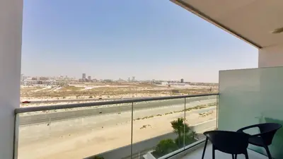 a balcony with a view of the beach from a building at Cosy Studio in Carson Tower C in Dubai