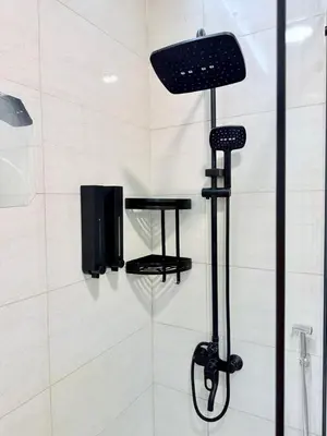 a shower with a black shower head in a bathroom at LivWithUs-Studio in One BR Setup, Dubai Marina in Dubai