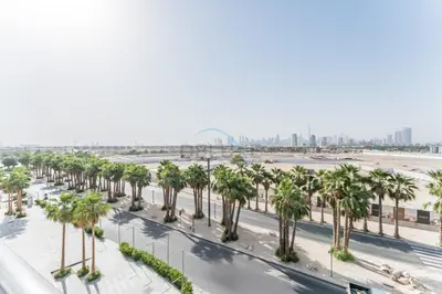 an aerial view of a street with palm trees at Studio with Glimpse of Burj Khalifa, Minutes from Downtown Dubai, MAG 930, Mohammad Bin Rashid City by Deluxe Holiday Homes in Dubai