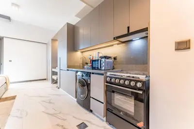 a kitchen with a stove and a sink at Studio with Glimpse of Burj Khalifa, Minutes from Downtown Dubai, MAG 930, Mohammad Bin Rashid City by Deluxe Holiday Homes in Dubai