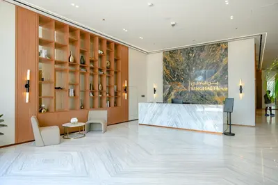 a lobby with a reception desk and a large painting at Bright 1BR in Binghatti House, Prime Location in Dubai