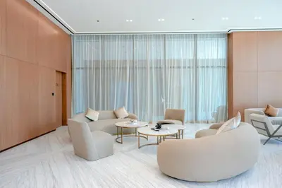 a living room with couches and chairs and tables at Bright 1BR in Binghatti House, Prime Location in Dubai