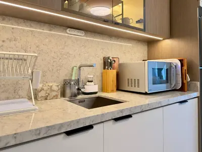 a kitchen counter with a microwave and a sink at Elegant and Stylish 1BR, Grand Blue in Dubai