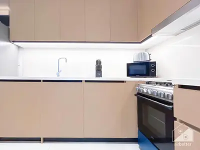 a kitchen with a stove and a microwave at Luxurious Burj Crown 2BR Apartment with Balcony in Dubai