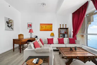 a living room with a white couch and red pillows at Ain Vista - Rimal 5 - JBR in Dubai