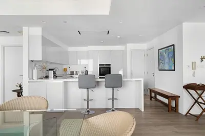 a white kitchen with a table and chairs in it at Ain Vista - Rimal 5 - JBR in Dubai