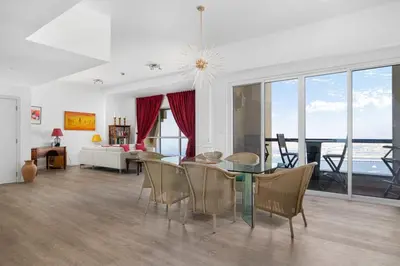 a dining room and living room with a table and chairs at Ain Vista - Rimal 5 - JBR in Dubai