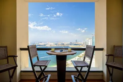 a table and chairs in front of a large window at Ain Vista - Rimal 5 - JBR in Dubai